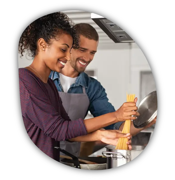 a couple cooking pasta together